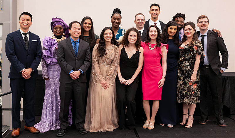 Facutly and students at a formal party.